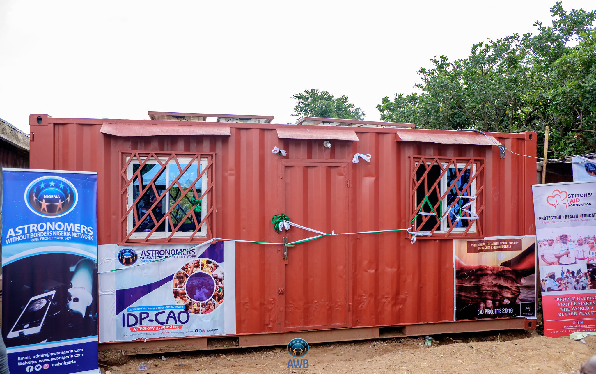 A shipping container with signs on the outside showing that it has been converted into a STEM center